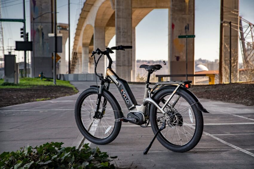 black electric bike parked on gray concrete pavement